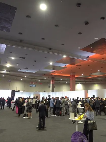 A wide shot of a large-scale corporate event during a meal service. This demonstrates our capacity to cater for hundreds of guests simultaneously, with multiple buffet lines to ensure smooth flow.