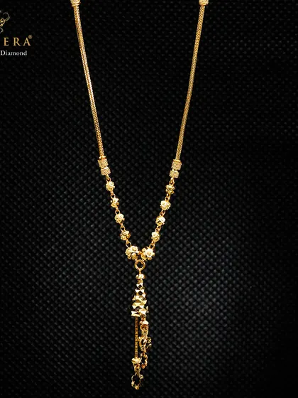 This lightweight gold mangalsutra-style chain features a decorative pendant with dangling elements. It offers a modern take on a traditional piece, designed for comfort and style.