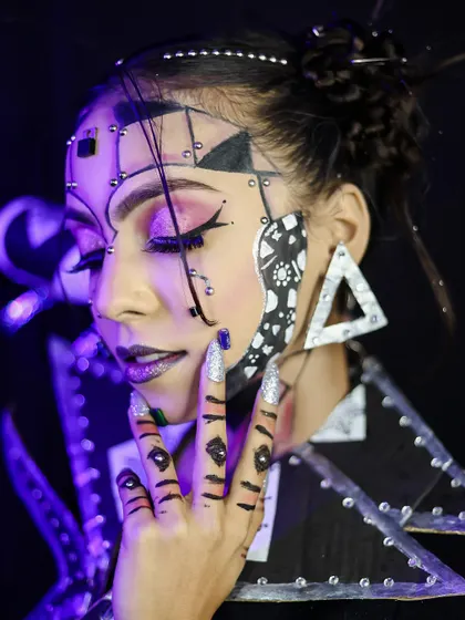 A profile shot that gives a different perspective on the complex, multi-layered makeup.