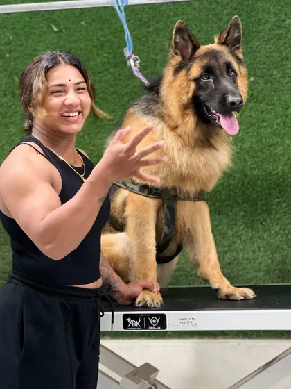 The bond I build with the dogs I groom is so important. This happy German Shepherd and I are all smiles after a successful and pleasant de-shedding session.