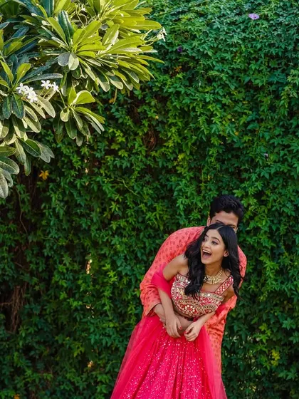 A playful lift and a burst of laughter. This shot is all about capturing the fun and carefree spirit of the couple during their outdoor shoot.