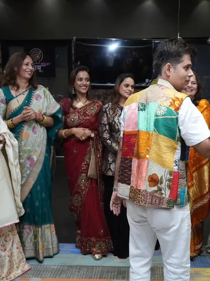 A candid shot of me interacting with guests at a Karwa Chauth event, making sure everyone is having a good time.