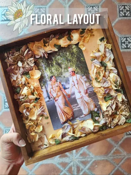 The floral layout process for the "Garden of Love" frame, showing how the flowers are arranged before the resin pour.