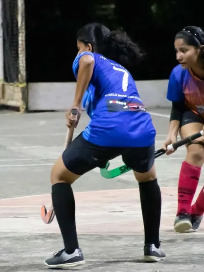 A player looks to pass to her teammate while being closely marked by a defender. This showcases the high level of skill and awareness our girls possess.