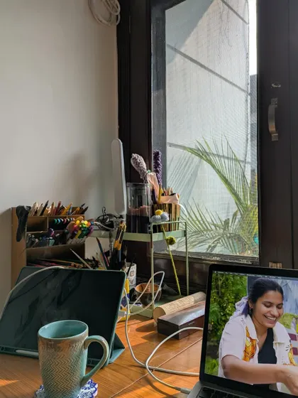 My desk setup, with my laptop showing a picture of me painting. It's a reminder of how far I've come.