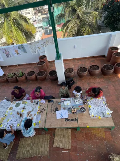 An overhead view of an art session in progress. Our large work tables and open layout allow for collaborative projects and give everyone enough space to spread out and create.