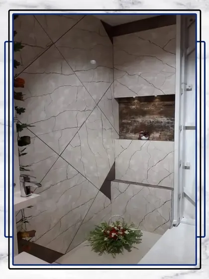 A sanctuary of luxury in every detail. This bathroom uses a unique tile pattern and a touch of greenery to create a space that feels both opulent and tranquil.
