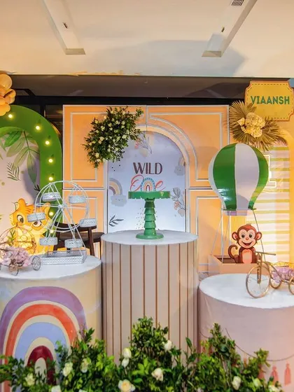 The full stage for Viaansh's boho 'Wild One' party. The design combines jungle animals, rainbows, and hot air balloons for a whimsical and adventurous theme.