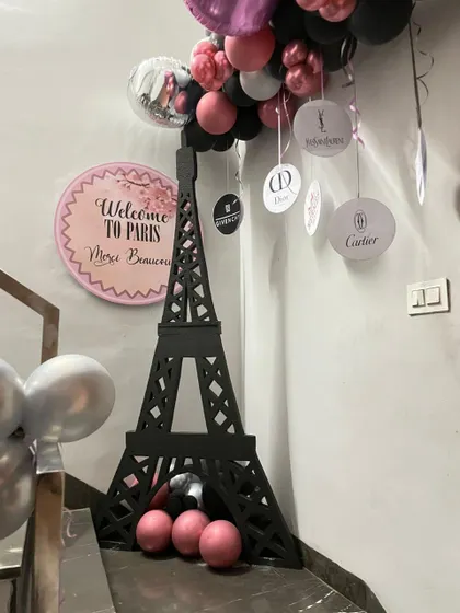 A close-up of the Paris-themed decor elements, including the Eiffel Tower prop and "Welcome to Paris" sign.