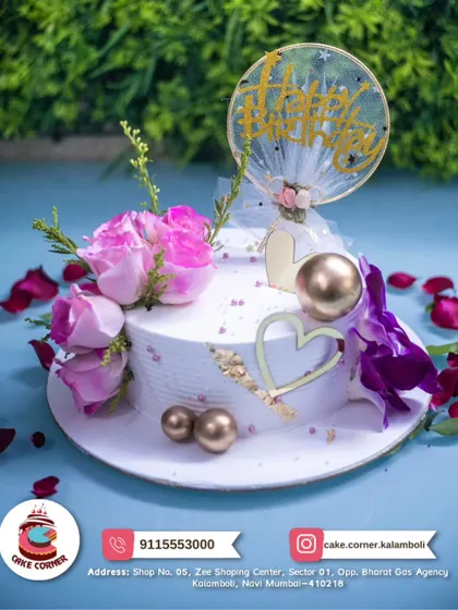A beautiful white cake decorated with fresh pink and purple flowers and gold hearts. The delicate design makes it perfect for a romantic and elegant celebration.