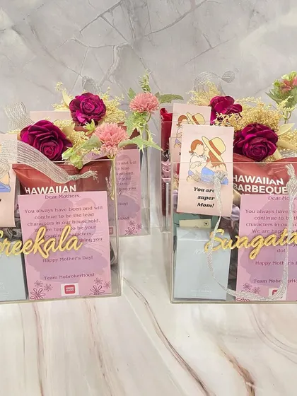 Personalized acrylic box favors we created for a corporate Mother's Day event. Each box includes a custom nameplate, a heartfelt note, and curated gifts.