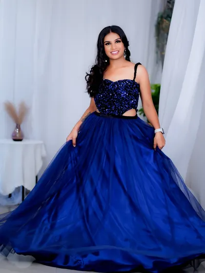 A stunning party look featuring a bold blue gown. I created a glamorous makeup look with a defined eye and glowing skin to match the drama of her sequined dress.