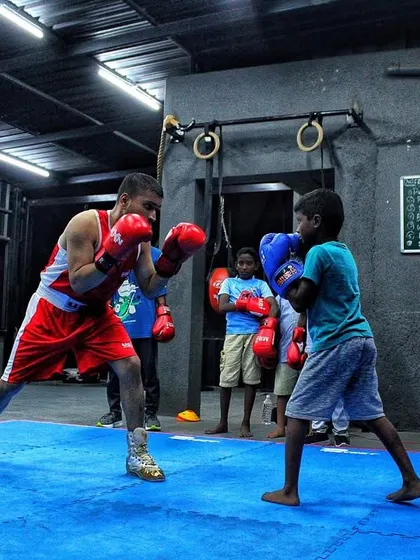 Age and size don't matter as much as heart. A younger boxer squares up with a more experienced fighter, showing no fear.