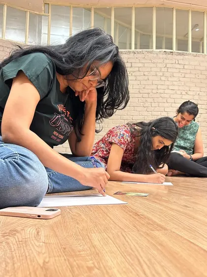 Participants engage in a creative writing exercise during the Rewilding circle. We use art as a tool for self-discovery and expression.