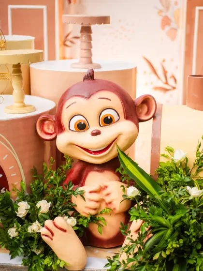 This adorable monkey prop, nestled in greenery, adds a playful and charming touch to the jungle theme. I focus on high-quality props that bring character and life to the party.