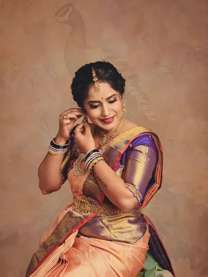 This is the same pose as the previous image but with a subtle peacock motif added to the backdrop. It shows how I can introduce artistic elements to enhance the traditional theme of a shoot.