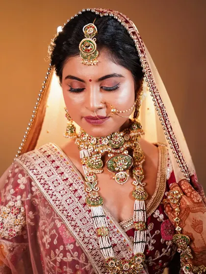 A moment of quiet grace. This shot captures the intricate details of the jewellery and the soft, blended eye makeup.