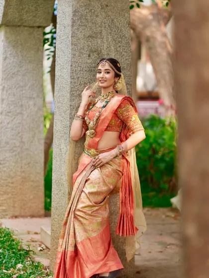 The complete look from head to toe. The way the temple jewellery drapes over the silk saree and the elegance of the matching waist belt (vaddanam) creates a truly timeless bridal portrait.