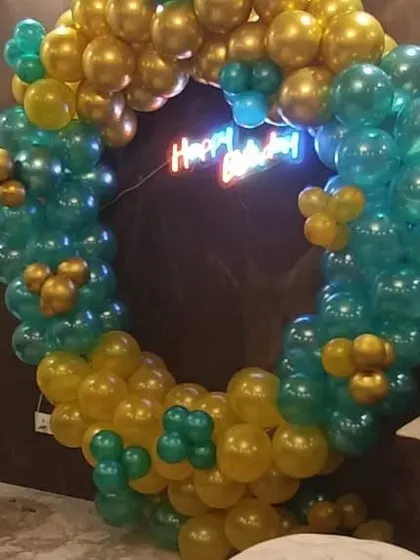 Another angle of the teal and gold balloon ring decoration. You can see how the circular frame is densely packed with balloons to create a full and luxurious effect, perfect for making a statement at an event.