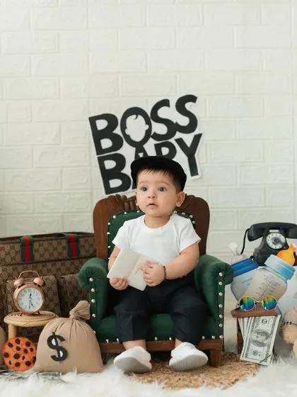 A serious moment for the Boss Baby. We use a variety of props like vintage phones, money bags, and a tiny briefcase to make the theme come alive.