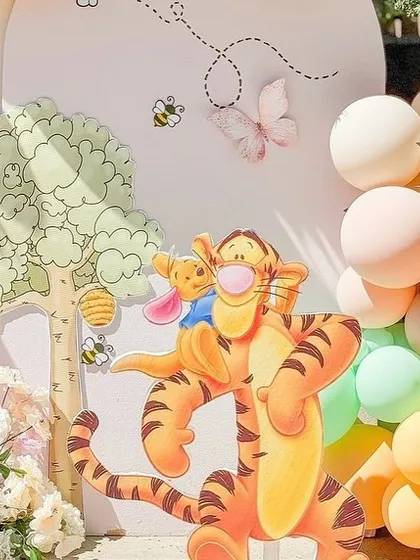 Tigger and Piglet join the party in this close-up of the vibrant, character-filled baby shower decor.