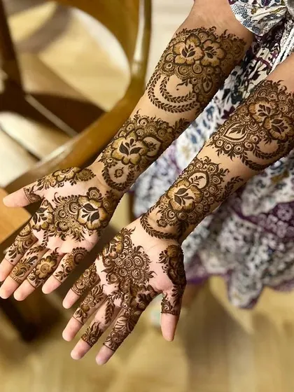 Another angle of the bridesmaid's mehndi, showing how the floral and vine patterns wrap around the hands and arms.