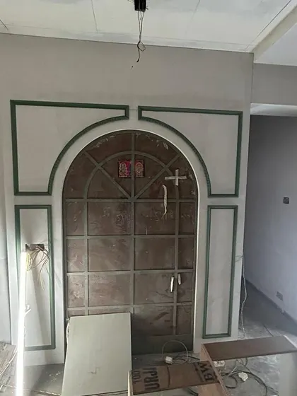 During construction: The framework for the grand arched mirror wall in the dining room takes shape. This shows the structural work behind the final look.