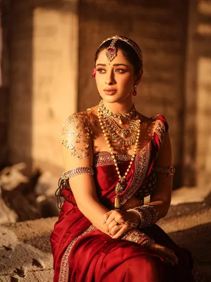 A serene portrait of Nyra Banerjee, capturing a pensive mood. The lighting and composition give this image a painterly quality, reminiscent of old royal portraits.