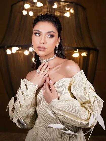 This avant-garde white dress with leaf-like sleeve details is paired with a clean, wet-look makeup style. This is an example of the high-fashion looks we create for portfolio development.