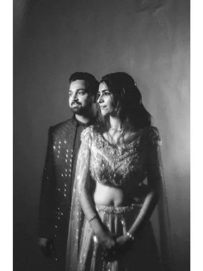 A moody and classic black and white studio-style portrait. The soft lighting and their thoughtful expressions give this photo a timeless, cinematic quality.