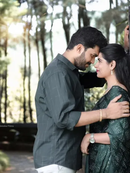 An intimate moment between the couple, using the natural light and forest-like background to create a serene mood.