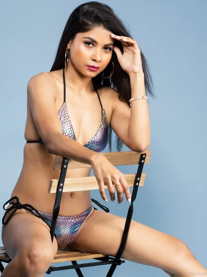 A color version of the same pose, highlighting the iridescent quality of the bikini fabric.