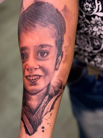 Portrait tattoos are a beautiful way to honor a loved one. I work from photographs to capture the exact likeness and expression, creating a timeless tribute like this portrait of a child.