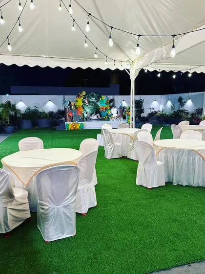 Our venue at night, ready for a birthday celebration under a well-lit marquee with clean and comfortable seating.