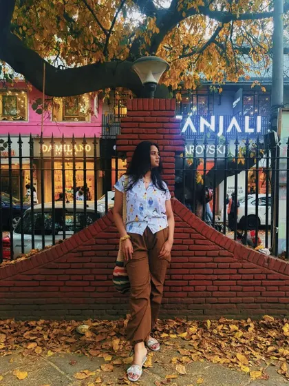 An autumn day in Khan Market calls for a comfy and quirky outfit. I'm wearing brown cargo pants with a fun printed shirt and a bohemian-style bag.