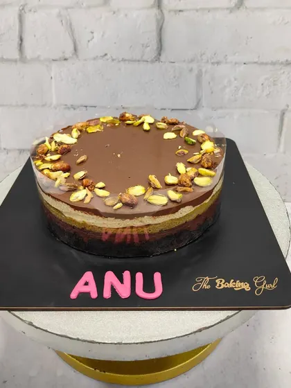 A custom-made pistachio and chocolate layered cake for a client named Anu. I love creating personalized cakes that taste as good as they look.