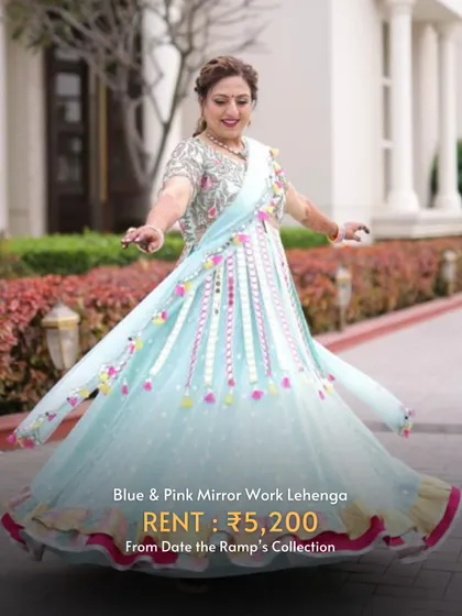 A playful blue and pink mirror work lehenga that is absolutely perfect for twirling during Garba nights.