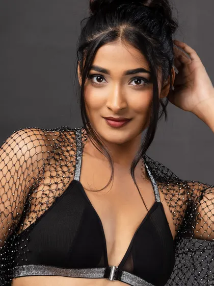 A friendly, smiling portrait of the model in the same outfit, showing her personality.