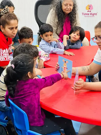 Our classes are designed for both children and parents to learn and grow together. Here, a group is fully engaged in a flashcard activity, a key part of our method for boosting memory and concentration.