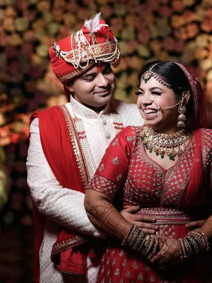 Capturing the pure, unscripted joy of a wedding day. This candid photo shows the bride's infectious laughter as her groom holds her close, a perfect memory of their happiness.