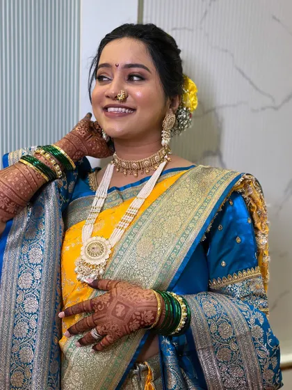 A happy, confident bride showing off her complete look, including the intricate henna design.