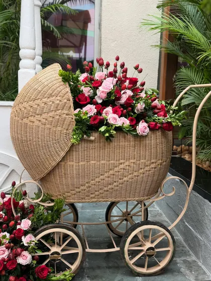 This vintage-style cane bassinet is a beautiful and elegant prop for a baby shower or a baby announcement event. It can be filled with flowers or gifts for a stunning display.
