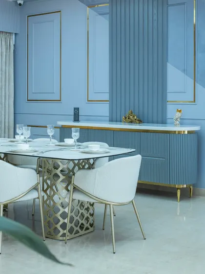 This shot highlights the custom crockery unit with its fluted design and the elegant dining chairs. Every element is carefully chosen to create a dining area that feels both luxurious and comfortable.