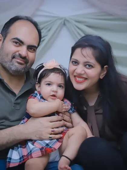 A lovely, simple family portrait. The parents and their toddler look towards the camera, creating a classic memory.