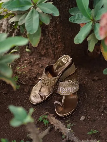 A detail shot of the bride's beautiful golden sandals, placed carefully in a natural setting. It's the small details that help tell the whole story.