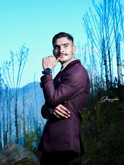 A thoughtful and stylish pose from the groom during his outdoor photoshoot. This kind of shot adds variety and personality to a wedding collection.