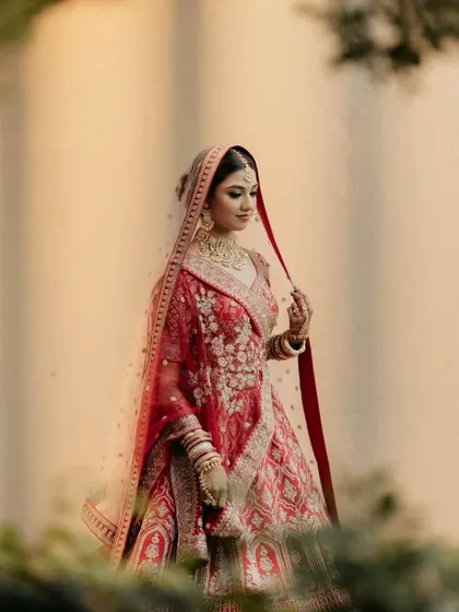 Bold and beautiful in red for her sangeet. This look features a classic glam eye and dewy skin, a timeless combination that makes any bride feel like a star.
