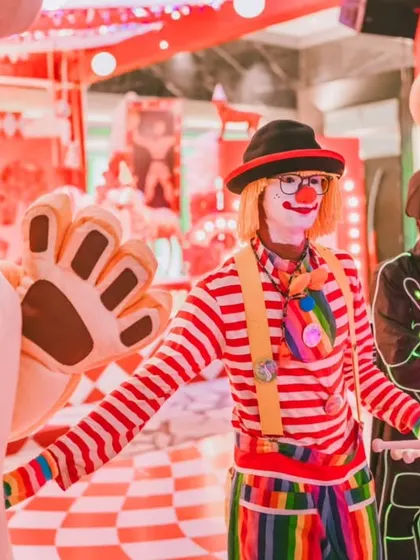 A colorful clown and futuristic LED performers entertain guests at the circus party. I love to mix classic entertainment with modern twists to create a unique and dynamic experience.