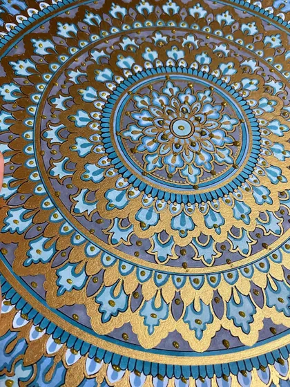 This intricate mandala, detailed with shades of blue and shimmering gold paint, is one of my favorite creations. I use high-quality acrylic sheets to ensure the colors are vibrant and the details are crisp, making it a perfect statement piece for any room.