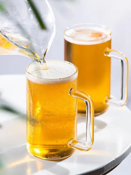 A pour shot of beer into a mug, with soft, natural light. This creates a different mood compared to more dramatic, hard-lit shots.